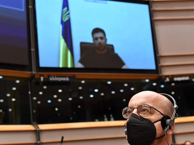 President of the European Council Charles Michel listens to Ukrainian President Volodymyr Zelensky (on screen) as he gives a live video address. Picture: AFP