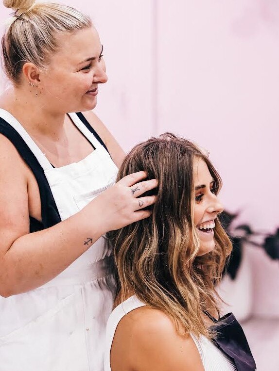 Hairdresser Ash Croker works on a client.