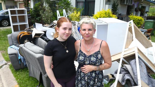 Hailey Heusdens with her mum Kerri Dowd outside their Kamerunga Villas home two weeks after flooding of the Barron River cut power to 131 properties. Picture: Peter Carruthers