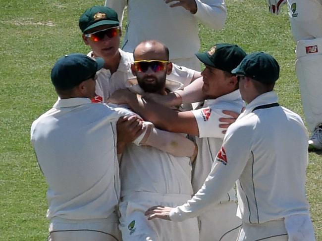 Australia's Nathan Lyon (3L, bottom) celebrates the wicket of India's Kuldeep Yadav with teammates during the third day of the fourth and last Test cricket match between India and Australia at The Himachal Pradesh Cricket Association Stadium in Dharamsala on March 27, 2017. ----IMAGE RESTRICTED TO EDITORIAL USE - STRICTLY NO COMMERCIAL USE----- / GETTYOUT---- / AFP PHOTO / PRAKASH SINGH / ----IMAGE RESTRICTED TO EDITORIAL USE - STRICTLY NO COMMERCIAL USE----- / GETTYOUT