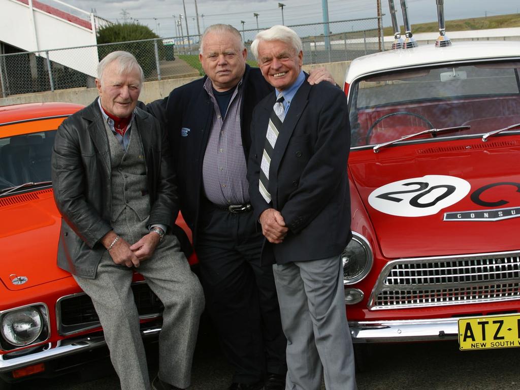 Bob Jane (centre) celebrates the launch of the Bob Jane T-Mart 1000 with his 1963 and 1964 winning co-drivers Harry Firth and George Reynolds in 2002. Picture: supplied