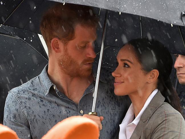 Prince Harry and wife Meghan, Duchess of Sussex, copped a drenching while in Victoria Park, Dubbo last month. Picture: Peter Parks