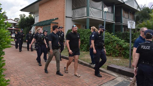 Police officers leaving an address in Berserker where the group spoke to neighbours.