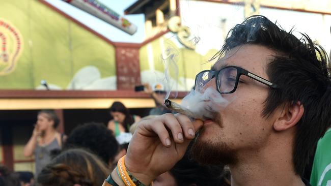 Travellers at the Mardi Grass festival smoke during the Global Marijuana March in the NSW town of Nimbin in 2016. Picture: AFP