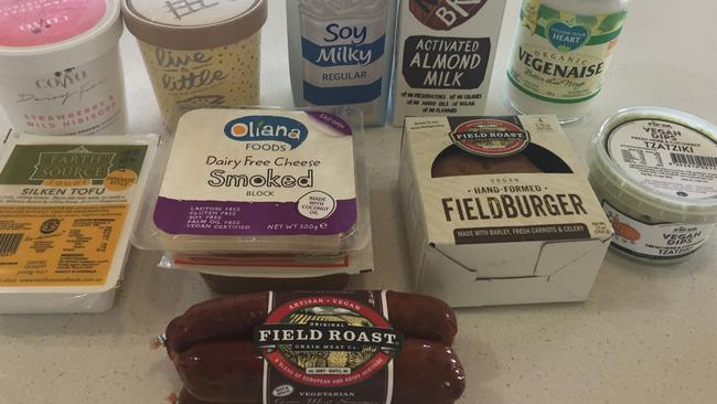 Vegan supermarket options: burgers, chipotle sausage, cheese and milk.