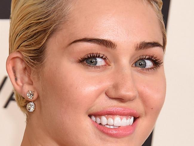 FILE - In this Sunday, Feb. 8, 2015 file photo, Miley Cyrus arrives at the 57th annual Grammy Awards at the Staples Center in Los Angeles. A convicted burglar has pleaded no contest to breaking into the home of Cyrus last year. The Los Angeles District Attorney’s office says Rusty Edward Sellner entered the plea to one count of first-degree residential burglary on Wednesday, Feb. 11, 2015. (Photo by Jordan Strauss/Invision/AP, File)