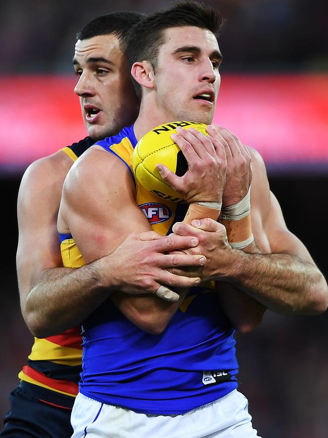 Walker latches onto Eagle Elliot Yeo. Picture: AAP Image/Mark Brake