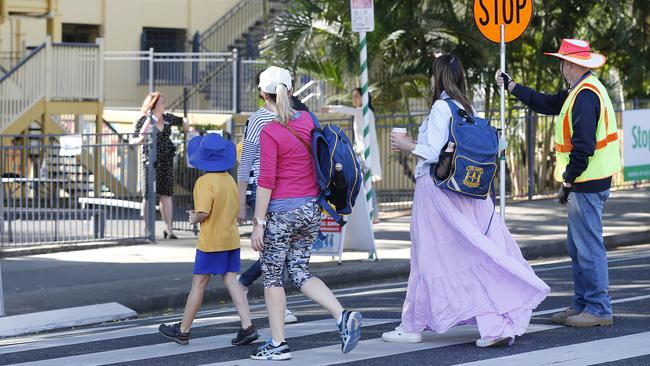 Parents pictured dropping off their kids at school in Brisbane.