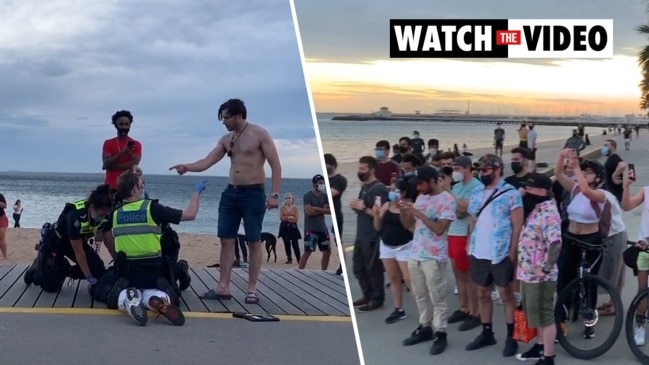 Man's violent scuffle with police at St Kilda beach