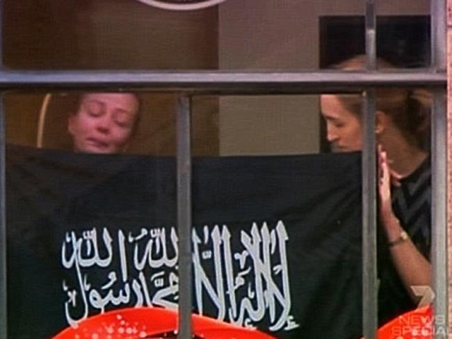 Marcia Mikhael and Katrina Dawson hold up a sign in the Lindt window.