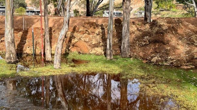 Floodwater has breached the Riverbend Caravan Park’s levee and the park evacuated. Picture: Shaun Edwards