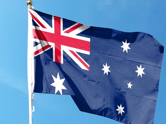 Australian flag in cloudy sky. Waving in the Sky