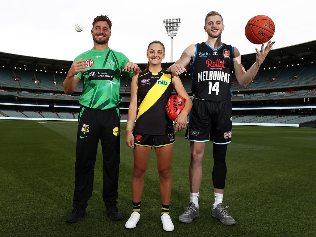 Lighting up the MCG with Melbourne Stars BBL gun Marcus Stoinis and Richmond AFLW jet Monique Conti. Picture: Michael Klein