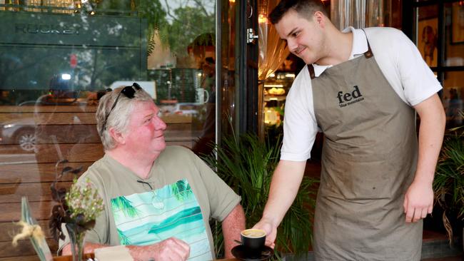 Fed’s Edan Lynch serves café regular Paul Grigg his “usual”. (AAP IMAGE / Angelo Velardo)