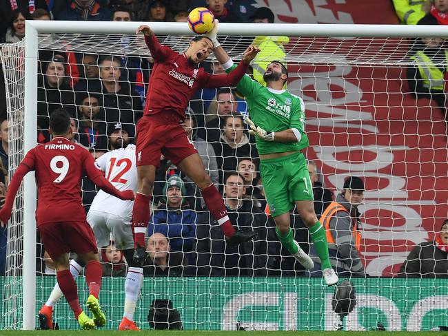 TOPSHOT - Crystal Palace's Argentinian goalkeeper Julian Speroni (C) punches under pressure from Liverpool's Dutch defender Virgil van Dijk (centre left) during the English Premier League football match between Liverpool and Crystal Palace at Anfield in Liverpool, north west England on January 19, 2019. (Photo by Paul ELLIS / AFP) / RESTRICTED TO EDITORIAL USE. No use with unauthorized audio, video, data, fixture lists, club/league logos or 'live' services. Online in-match use limited to 120 images. An additional 40 images may be used in extra time. No video emulation. Social media in-match use limited to 120 images. An additional 40 images may be used in extra time. No use in betting publications, games or single club/league/player publications. /