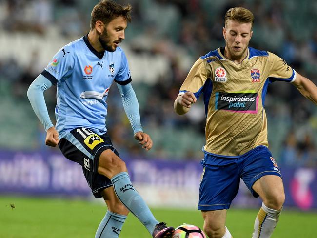 Milos Ninkovic of Sydney FC and Andrew Hoole of Newcastle Jets. Picture: AAP