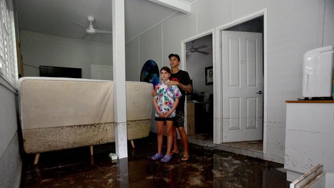 Tuesday February 4. Heavy rain causes flooding in North Queensland. Bluewater residents Anthony Waugh, with daughter Nyah, 9, at the ground floor of their Forrestry Road home inundated by a fast rising Bluewater Creek. Picture: Evan Morgan
