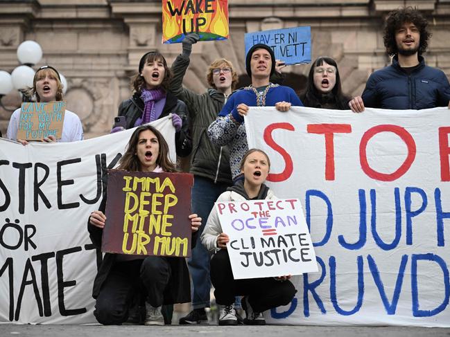 Greta Thunberg holds a banner as she and other climate activists attend a climate protest in the centre of Stockholm. Picture: Jonathan Nackstrand/AFP