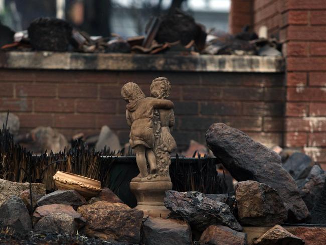 Peter Inkster recovered a statue from the burnt out home of his 84-year-old mother-in-law. Picture: Gary RamageMr Inkster loads the special statue onto his ute. Picture: Gary Ramage