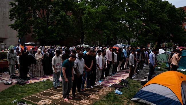 People pray at an encampment at University Yard at George Washington University.