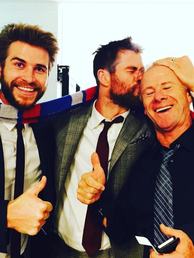 Liam, Chris and their dad Craig Hemsworth celebrating a Western Bulldogs win in 2016.