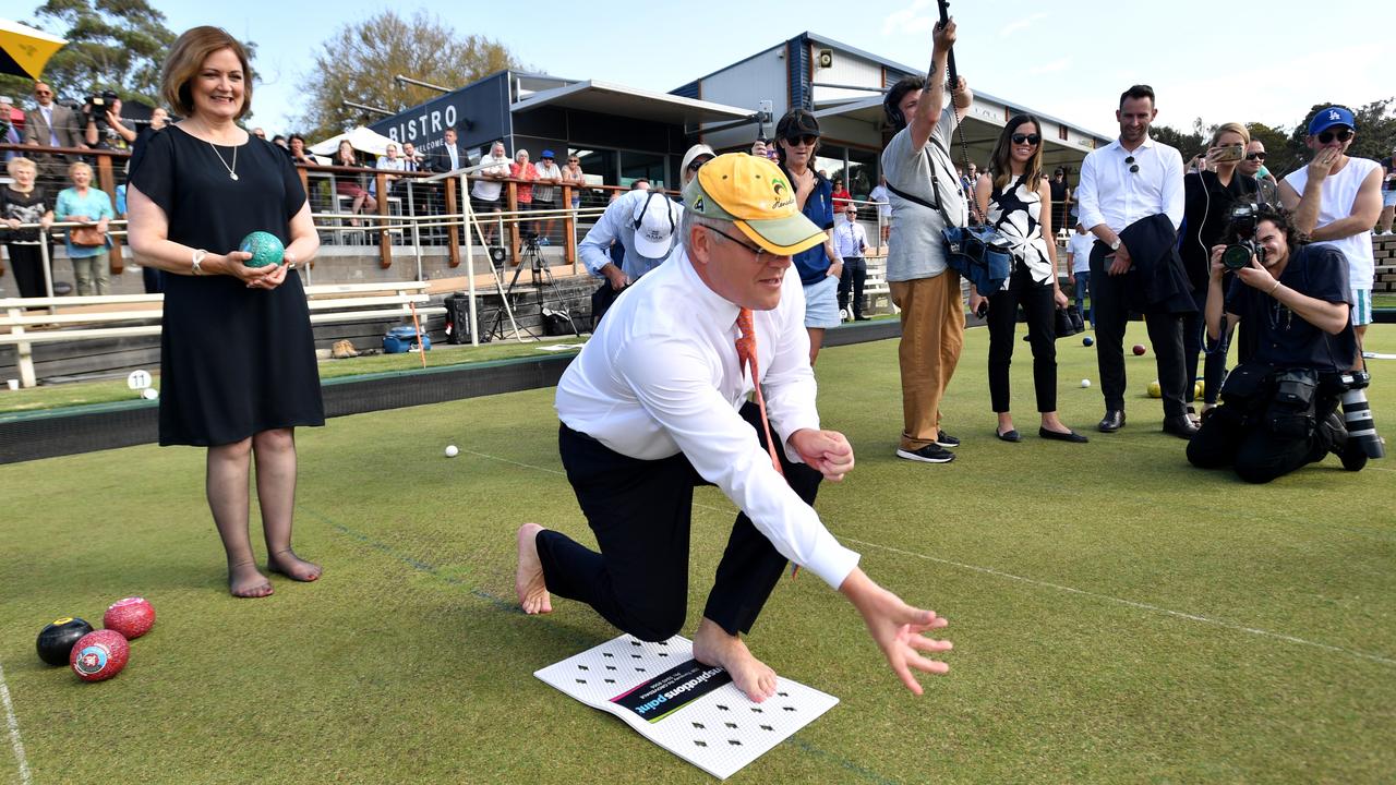 Prime Minister Scott Morrison and Liberal member for Corangamite Sarah Henderson play bowls at the Torquay Bowls Club near Geelong on the campaign trail. Picture: Mick Tsikas/AAP