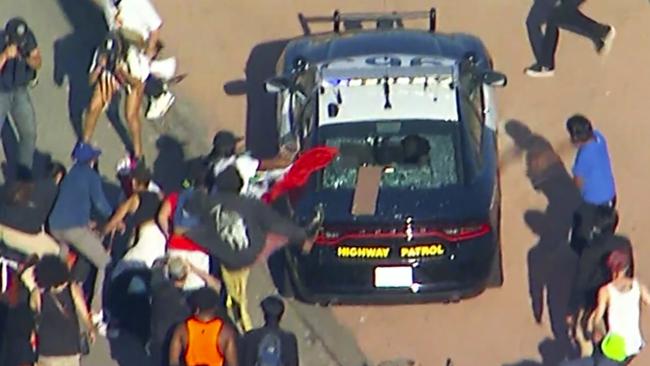 A California Highway Patrol cruiser is attacked by protesters. Picture: AP