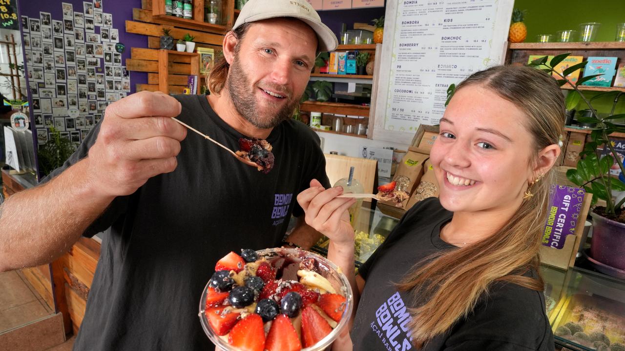 Dale Brewster, with staff member Ellie Bennier, opened Bomdia Bowls, in Glenelg, after a surfing holiday in Hawaii, where he tried acai desserts for the first time. Picture: Dean Martin