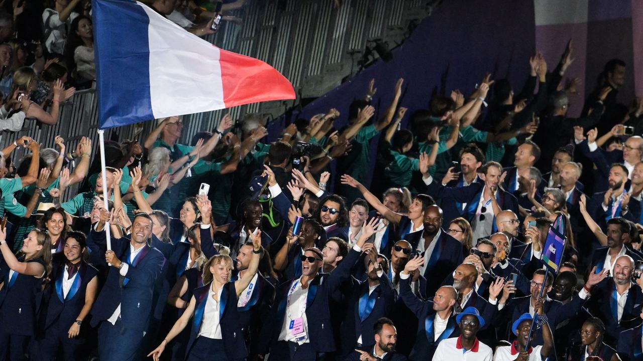 France's Paralympic flag bearer Alexis Hanquinquant with the French delegation are all smiles at the Place de la Concorde. Picture: Bertrand Guay/AFP