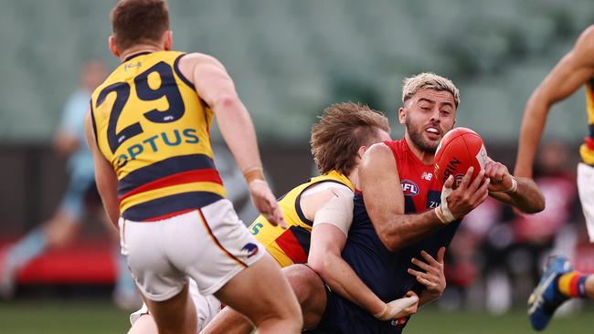 Christian Salem handballs clear as he is tackled during the final quarter. Picture: Michael Klein