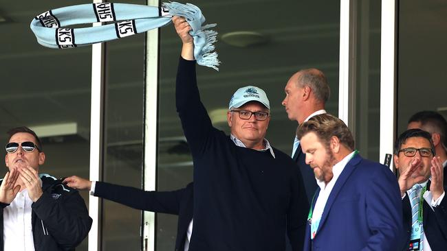 Going mask-free, Scott Morrison waves a scarf around while Victoria is in coronavirus crisis. Picture: News Corp