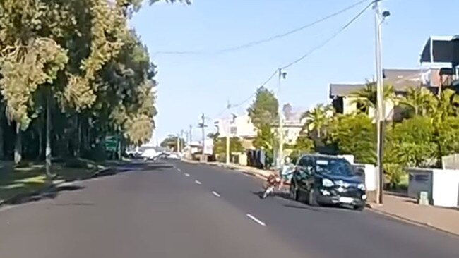 Hervey Bay motorcyclist falls to the ground after colliding with a car. Pic: Facebook