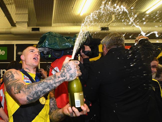 Dustin Martin pops some champagne in the rooms after winning the 2017 AFL Grand Final. Picture: Quinn Rooney/Getty Images