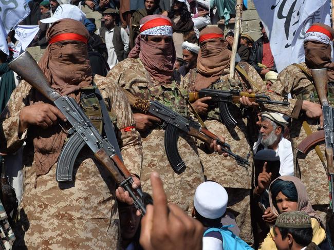 TOPSHOT - Afghan Taliban militants and villagers attend a gathering as they celebrate the peace deal and their victory in the Afghan conflict on US in Afghanistan, in Alingar district of Laghman Province on March 2, 2020. - The Taliban said on March 2 they were resuming offensive operations against Afghan security forces, ending the partial truce that preceded the signing of a deal between the insurgents and Washington. (Photo by NOORULLAH SHIRZADA / AFP)