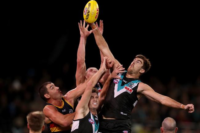 Power’s Scott Lycett flies high to spoil the make against the Crows at Adelaide Oval. Picture: James Elsby/Getty