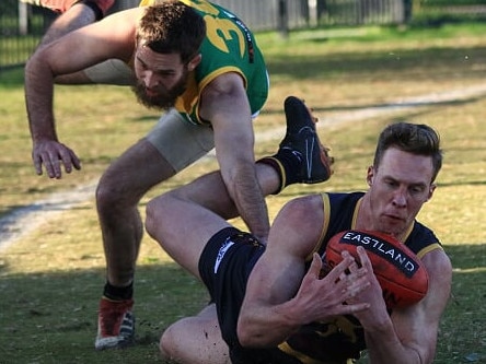 Jake Summers dives for a mark. Picture: Davis Harrigan