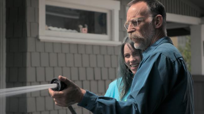 Dad shows Billie how to wash her ‘Dodge Challenger’ dream car. Picture: Apple TV