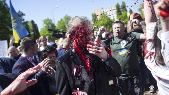 Russia's Ambassador to Poland Sergey Andreev has been drenched in red paint by demonstrators in Warsaw. Picture: Twitter/WARUKRAINE2022