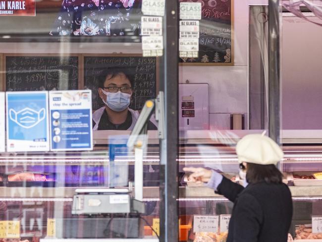 SYDNEY, AUSTRALIA - AUGUST 25: A woman standing on the street purchases meat from a butcher shop in Ashfield Civic Centre in Ashfield on August 25, 2021 in Sydney, Australia. COVID-19 lockdown restrictions remain in place across New South Wales as the state continues to grapple with high COVID-19 case numbers in the community. Tightened restrictions were introduced this week, including a curfew for residents in the 12 local government areas of concern in the west and south-west of Sydney. The curfew from 9pm to 5am each night is in addition to a further tightening of restrictions in hot spot suburbs that came into effect at 12:01 am Monday, with residents in those areas now also limited to just one hour of outdoor exercise per day and the introduction of worker permits. Face masks are now also mandatory outdoors across NSW unless exercising. (Photo by Jenny Evans/Getty Images)