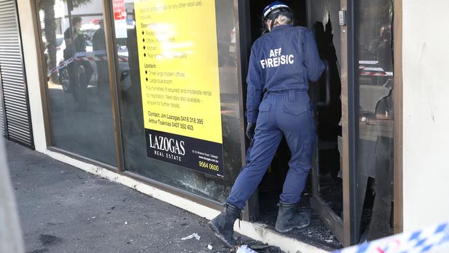 Forensic police investigate the cause of the blaze. Picture: David Crosling