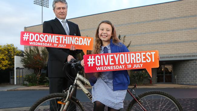 CEO of Wests Campbelltown Tony Matthew and 11 year old Tia Brennen, who started a charity to collect old bikes, repair them and give them to the underprivileged. Picture: Robert Pozo