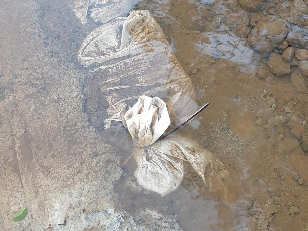 Plastic sandbags along the crossing which have now been concreted over. Photo: Barbara George