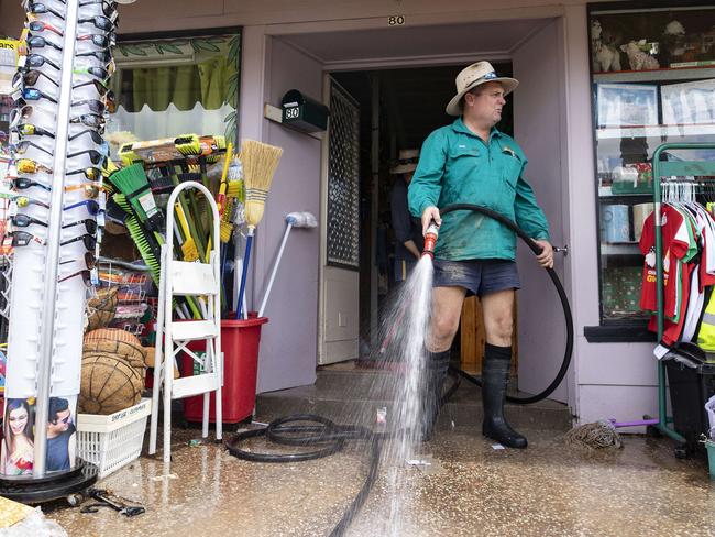 Community members gathered together to help clean up the mess after the town was inundated with floodwater. Picture Lachie Millard