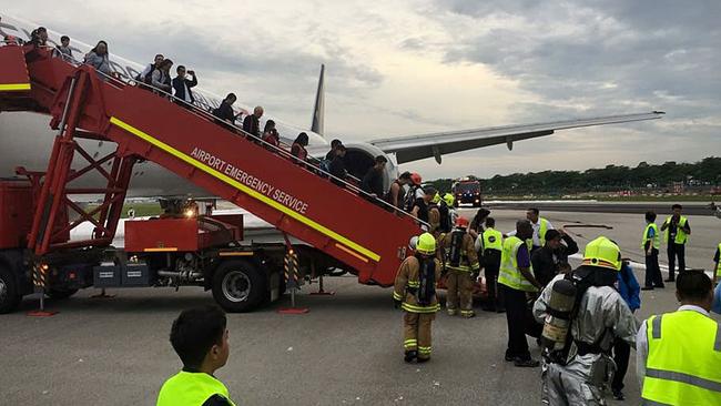 Passengers are eventually evacuated from the plane. Picture: Lee Bee Yee/AFP