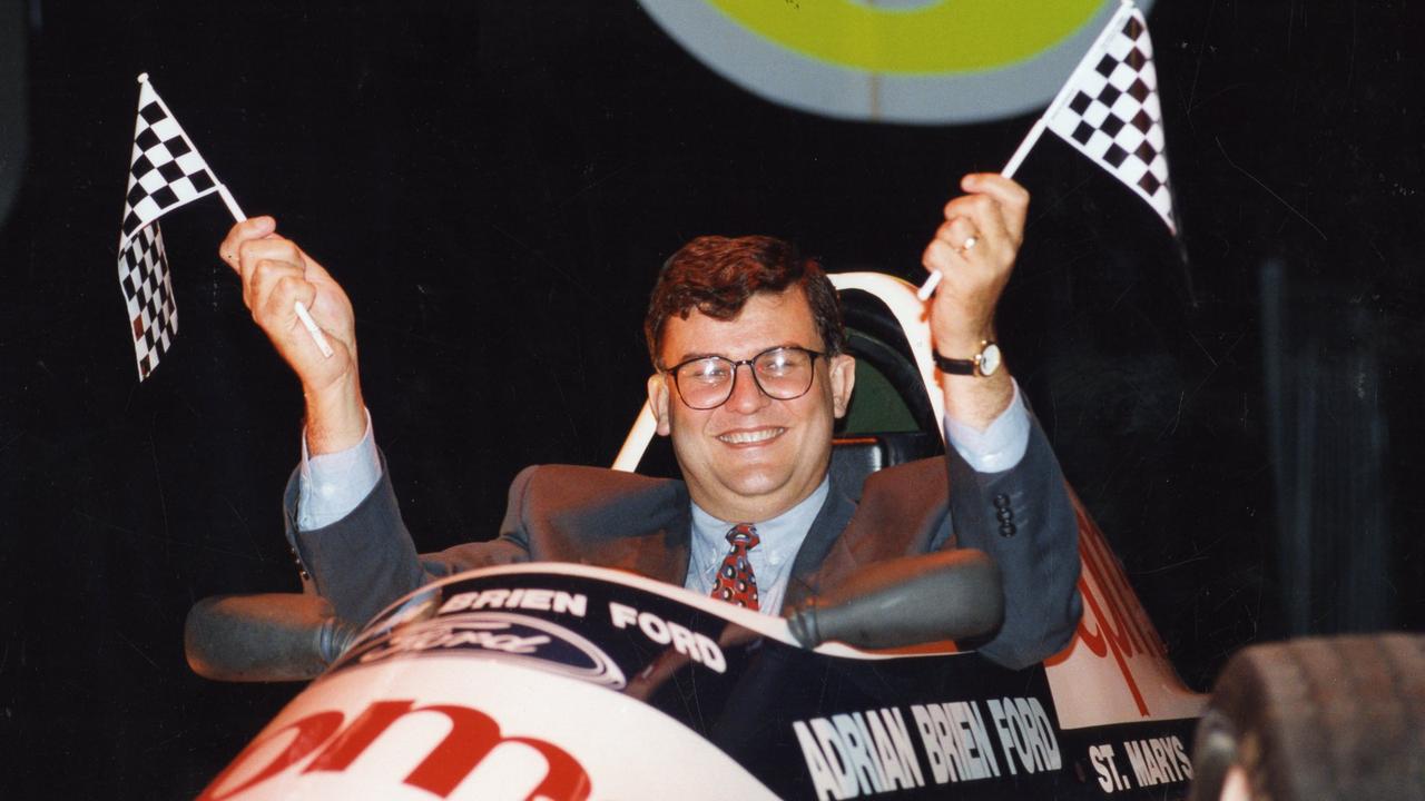 SA Premier Lynn Arnold sitting in a racing car waving two mini chequered flags at the official launch of Australian Formula One Grand Prix in 1992. Picture: File