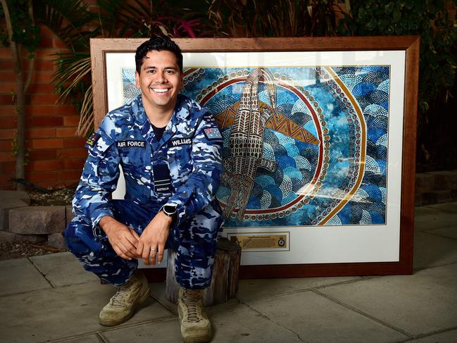 Indigenous Liaison Officer, FLT LT David Williams with Townsville artist Linda Oliver's painting. Picture: Shae Beplate.