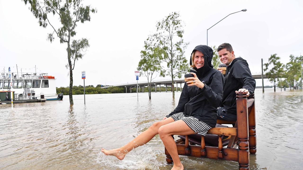 Bradman Ave remains closed as residents prepare for more rain and heavy flooding to hit the Sunshine Coast. Out having their morning coffee are Jane and Calvin Coffey. Picture: Patrick Woods.