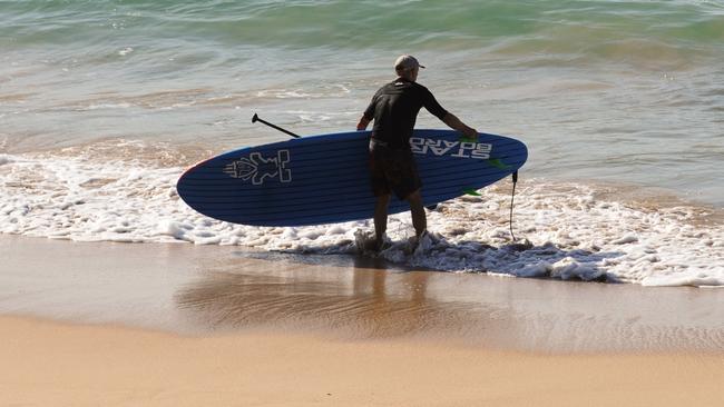 A lone surfer at Cronulla Beach on March 28. Picture: Simon Bullard/AAP