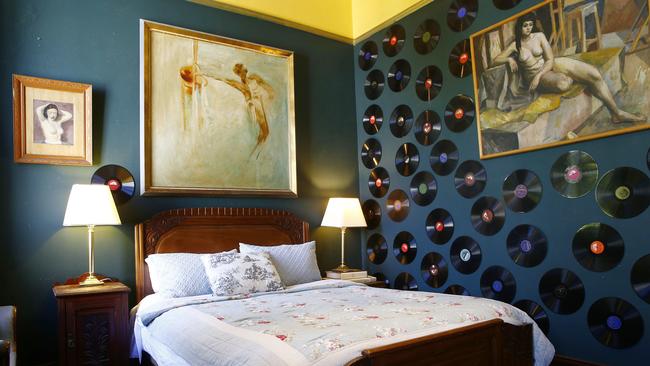 Guest bedroom features nude studies surrounded by collected 78 records. Picture: John Appleyard