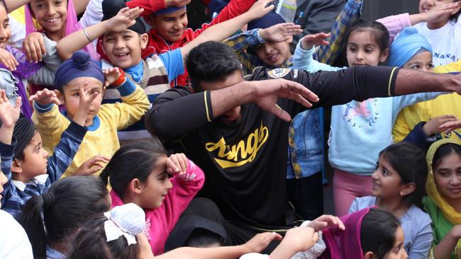 Amritpal Singh has fun with the children at the Guru Nanak Punjabi School in Glenwood. Picture: Sydney Kings